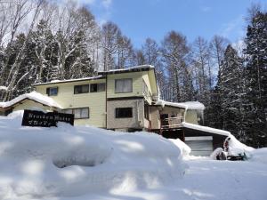 a house with a lot of snow in front of it at Brocken Hutte in Hakuba +5 photos