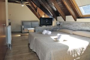 Llit o llits en una habitació de Aparthotel La Vall Blanca