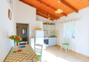 a kitchen with a table and chairs in a room at Villa Sevi in Gaios