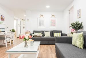 a living room with a couch and a table at Apartment Sol Gran Vía in Madrid