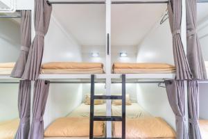 a room with two bunk beds in a house at Saiyud Hostel in Mae Hong Son