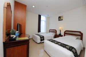 Postel nebo postele na pokoji v ubytování Palm Inn Ampang Point