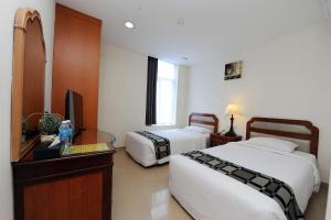 Postel nebo postele na pokoji v ubytování Palm Inn Ampang Point