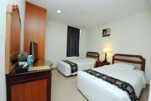 Postel nebo postele na pokoji v ubytování Palm Inn Ampang Point