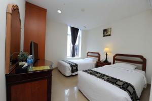 Postel nebo postele na pokoji v ubytování Palm Inn Ampang Point