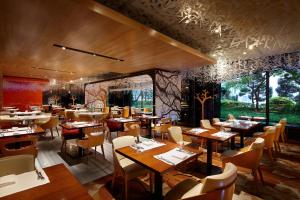 a dining room with wooden tables and chairs at Lotte Hotel Seoul in Seoul