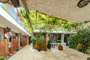 an internal courtyard of a building with trees and plants at Hotel Savojo in Petrovac na Moru
