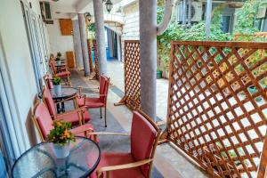 a balcony with a table and chairs and a fence at Hotel Savojo in Petrovac na Moru