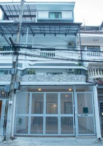 een wit gebouw met een grote poort ervoor bij Airee Premier Residence in Bangkok