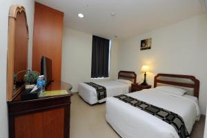 Postel nebo postele na pokoji v ubytování Palm Inn Ampang Point