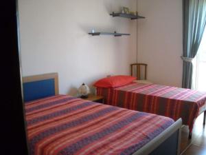 Postel nebo postele na pokoji v ubytování B&B Villa Le Palme Scalea