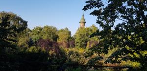 una torre en medio de un bosque de árboles en ELLA Apartment Timisoara no9, en Timisoara