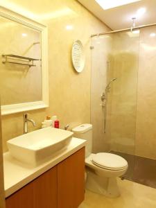 a bathroom with a sink and a toilet and a shower at Graha Padma Avonia in Semarang
