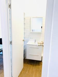 a bathroom with a sink and a mirror at Exclusive New Apartment in Benalmádena