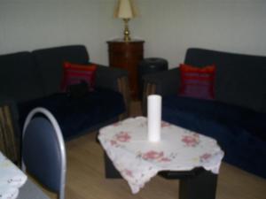 a living room with a table with a candle on it at charlier 32 in Blankenberge