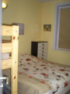 a bedroom with a bunk bed with a dresser and a window at charlier 32 in Blankenberge