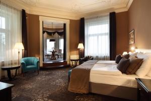 a hotel room with a large bed and a large window at Le Palais Art Hotel Prague in Prague