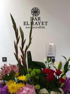 a bouquet of flowers in front of a sign at Dar El Hayet in Tangier