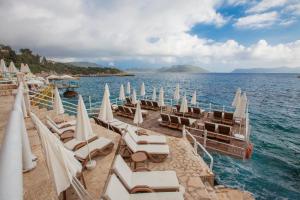 a group of chairs and umbrellas on a beach at Medusa Hotel in Kas