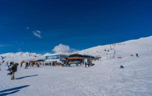 a group of people in the snow on a ski slope at Redco №1 Apartament Gondola LIft in Gudauri