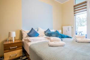 a bedroom with two beds with a blue stuffed animal on them at Apartament Blue Island in Kołobrzeg +25 photos