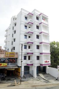 a white building with purple balconies on it at White Tulip Residency in Puducherry