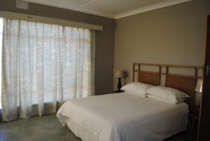 A bed or beds in a room at Bateleur Nature Reserve