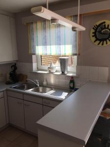 a kitchen with a sink and a window at Casa CJ in Ostend