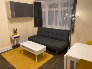 a living room with a couch and a table at Apartment 20 @ Excel London in London