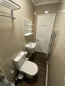 a bathroom with a white toilet and a sink at Apartment 20 @ Excel London in London