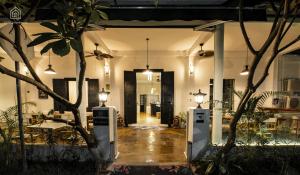a lobby of a house with trees and lights at SYRI Boutique Guesthouse Restaurant & Cafe in Vientiane
