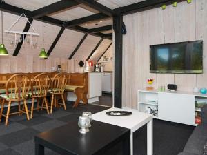 a living room with a kitchen and a dining room at 6 person holiday home in R m in Toftum