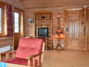 a living room with a chair and a television at 4 person holiday home in olden in Olden