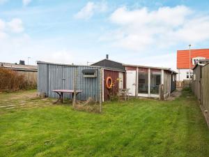 a backyard with a shed and a picnic table at 5 person holiday home in Thybor n in Thyborøn