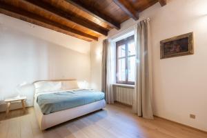 a bedroom with a bed and a window at casa Torre Sineo, medieval tower in Alba