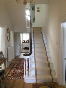 a staircase in a home with a white stair case at Park House in Budleigh Salterton