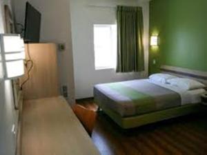 a hotel room with two beds and a window at Motel 6-Brownsville, TX North in Brownsville