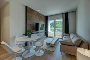 a living room with a couch and a table and chairs at Arveskida Suite Apartment in Cagliari