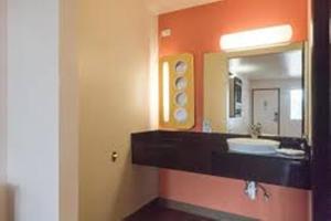 a bathroom with a sink and a mirror at Motel 6-Brownsville, TX North in Brownsville