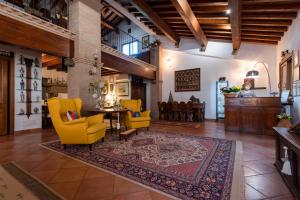 a living room with yellow chairs and a table at Agriturismo La Rombaia in Castiglione della Pescaia