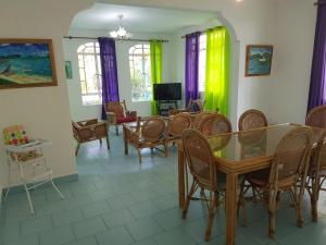 a dining room with a table and chairs at Lapiroguevilla (Tourist resident licence 03596) in Pereybere