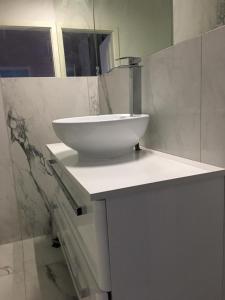 a white sink sitting on top of a counter in a bathroom at Villa Rosa Bad Camberg in Bad Camberg