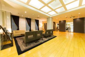 a lobby with a waiting room with chairs and a table at Hotel il Grande Umeda in Osaka