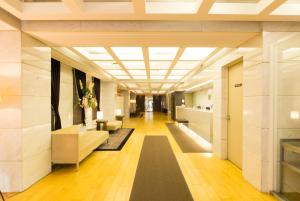 a hallway in a building with a large ceiling at Hotel il Grande Umeda in Osaka