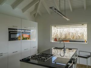 
a kitchen with a stove top oven and a sink at Beautiful Villa In Jan ThieL Near The Beach in Jan Thiel
