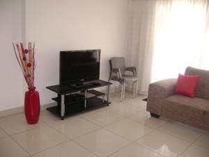 A television and/or entertainment centre at North Beach Durban Apartments
