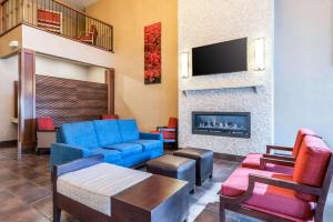 a living room with a couch and a fireplace at Comfort Suites Yakima in Yakima