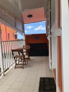 a balcony with two chairs and a table at A LA CLAIRE FONTAINE in Sainte-Suzanne