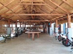 a barn with a table and bikes parked in it at Istana Ombak Eco Resort in Pacitan