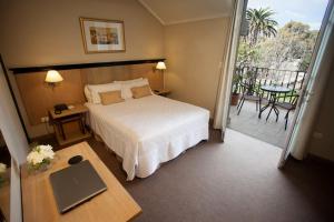 Cama ou camas em um quarto em Argentino Hotel